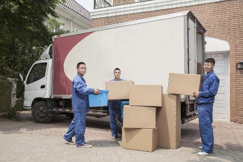 Removal staff handling furniture in a Surrey property