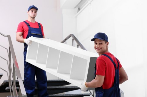 Removal team helping a Surrey home move with packed boxes and furniture