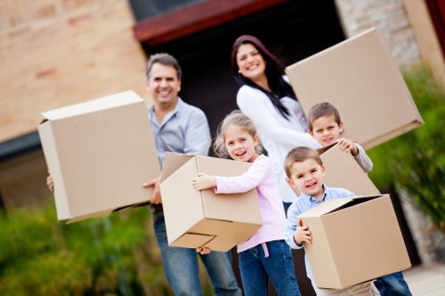 Professional packers preparing fragile household items for transport