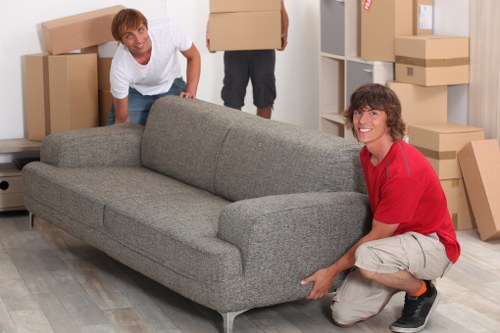 Removal team handling boxes and furniture for a Surrey move