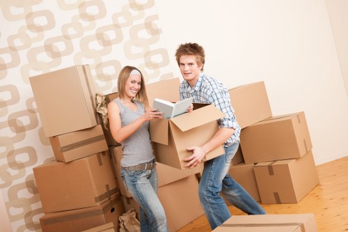 Professional movers handling furniture in a Surrey street with parking considerations