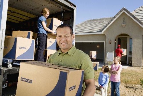 Furniture and boxes being loaded into a Surrey removal van